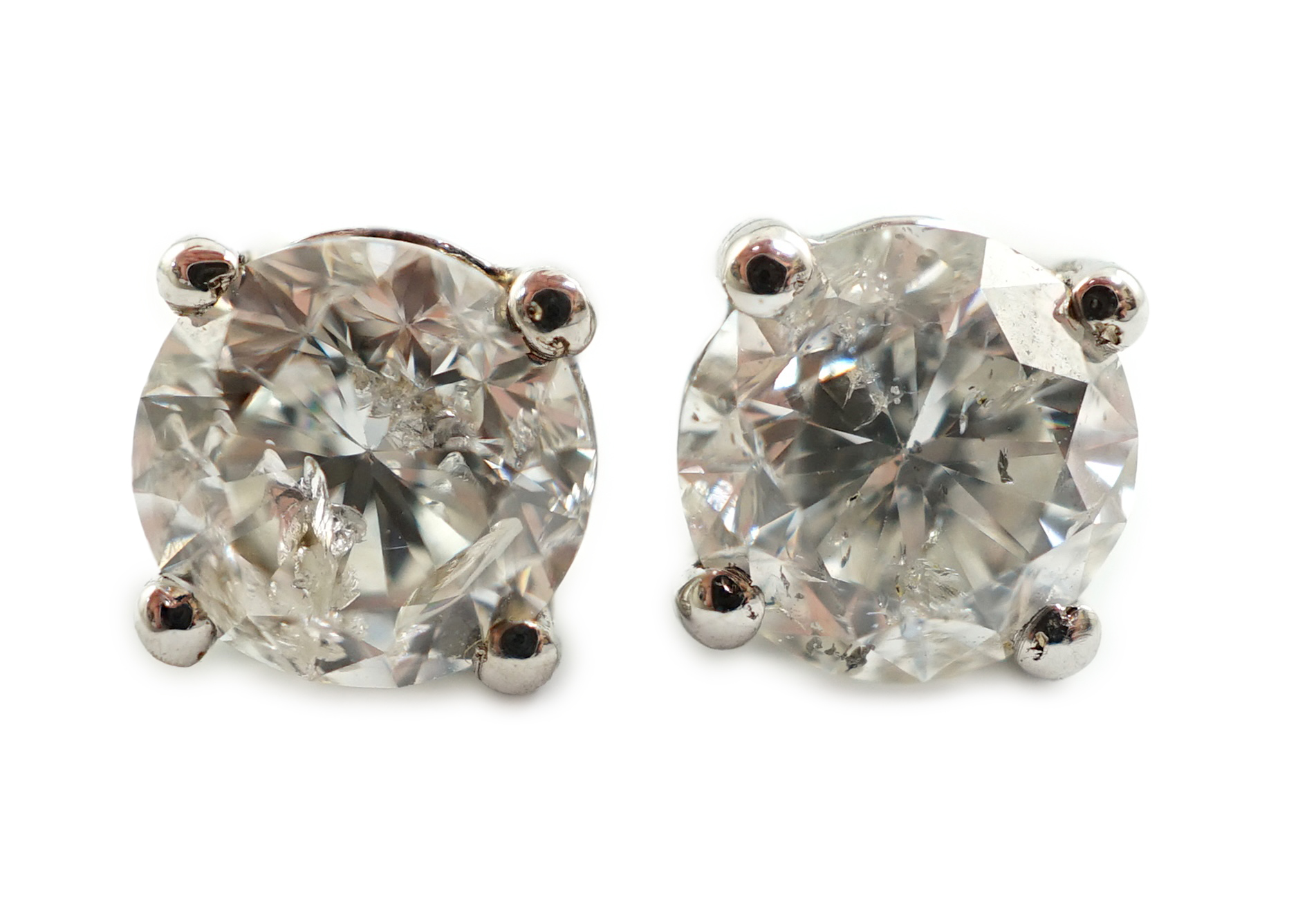 A modern pair of 18k white gold and round brilliant cut solitaire diamond set ear studs